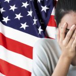 Stressed person in front of American flag